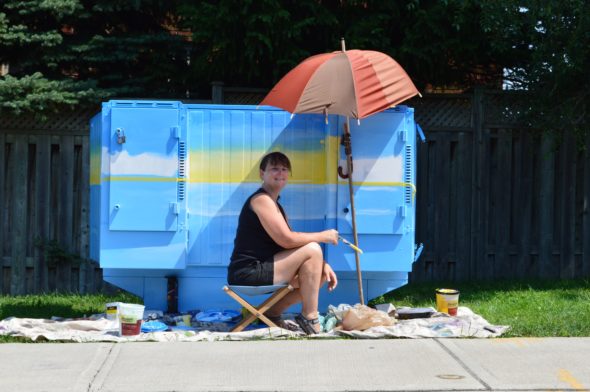 De Anne Lamirande painting Bell Box mural at Blantyre and Gerrard